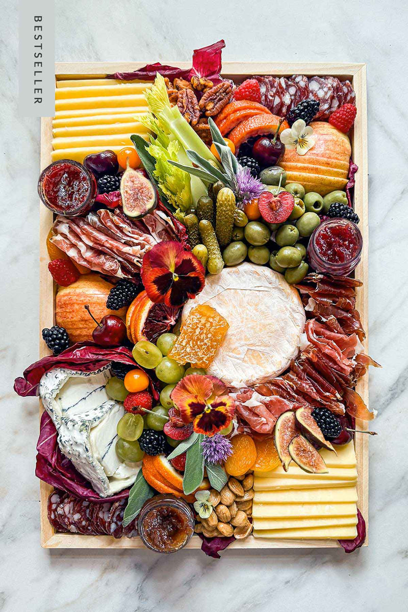 Artisanal Cheese & Charcuterie handcrafted and styled on a charcuterie board with Vermont't Finest cheeses, charcuterie meats, antipasti, fruits, nuts, and local preserves.