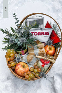 The Après Ski Gift Basket in the snow, filled with Vermont's finest alpine cheese and après ski cheese board ingredients.