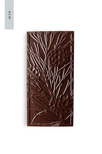 A Salted Caramel Chocolate Bar with sea salt that is pressed with a pattern of trillium flowers.