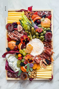 A new Artisanal Cheese & Charcuterie handcrafted and styled on a charcuterie board with Vermont't Finest cheeses, charcuterie meats, antipasti, fruits, nuts, and local preserves.