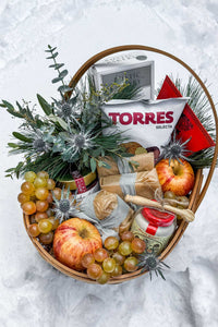 The Après Ski Gift Basket in the snow, filled with Vermont's finest alpine cheese and après ski cheese board ingredients.