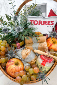 The Après Ski Gift Basket in the snow, filled with Vermont's finest alpine cheese and après ski cheese board ingredients.