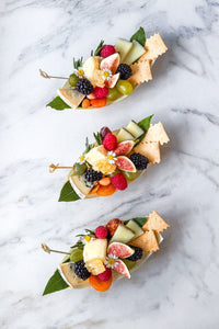 A trio of fresh garden to table single serve cheese grazing boats, filled with Vermont's finest cheese and the season's freshest fruits and vegetables accented with fresh flowers and herbs.