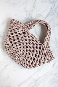 A hand crocheted market basket bag in beige.