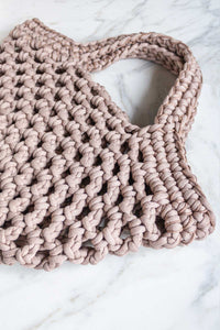 A hand crocheted market basket bag in beige.