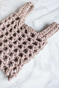 A hand crocheted small market tote bag in beige.