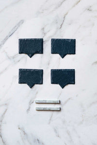 A box set of natural slate cheese markers with soapstone chalk.