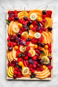 A fresh seasonal fruit platter available for delivery in Vermont, abundant and overflowing with fresh melons, stone fruit, raspberries, cherries, kiwi, and seasonal fruit favorites.